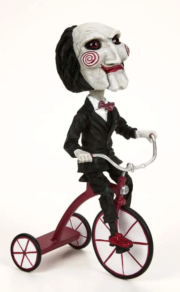 saw puppet on tricycle headknocker